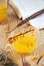 Tea with sea-buckthorn orange berries in a glass cup.