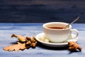 Tea served with spoon, sugar and decor as cinnamon. Mug filled with black brewed tea, spoon and autumn fallen leaves on Royalty Free Stock Photo