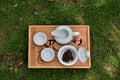 Tea service, white china with black tea in the natural background Royalty Free Stock Photo