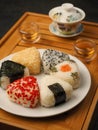 Tea set for the ceremony and Onigiri. Various shapes and fillings on a plate. Healthy snack. Japanese rice ball. Top view Royalty Free Stock Photo