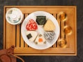 Tea set for the ceremony and Onigiri. Various shapes and fillings on a plate. Healthy snack. Japanese rice ball. Top view