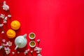 Tea set with oranges and peach blossom on red cloth background Royalty Free Stock Photo