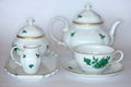 A tea set in white porcelain with gold and green decoration Royalty Free Stock Photo