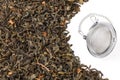 Tea strainer on a chain, with a mixture of dry green large-leaf tea with soursop, isolated on a white background. Royalty Free Stock Photo