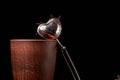 tea strainer with a cup and black tea on wooden table on dark background. Selective focus Royalty Free Stock Photo