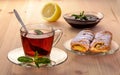 Tea with strudel mint and jam and lemon