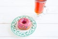 Tea and sugar donut on white wooden table Royalty Free Stock Photo