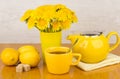 Tea with sugar and lemon, bouquet of dandelions Royalty Free Stock Photo