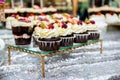 Tea table, a lot of beautiful, bright and delicious cupcakes-cupcakes with cream, strawberries Royalty Free Stock Photo