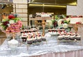 Tea table, a lot of beautiful, bright and delicious cupcakes-cupcakes with cream, strawberries Royalty Free Stock Photo