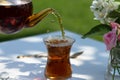 Tea from teapot pours into armudu glass Royalty Free Stock Photo