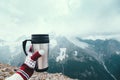 Tea in thermos over mountains view