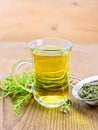 Tea of thyme in mug with strainer on board Royalty Free Stock Photo