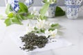 Tea time concept.Cups and teapot, green tea and fresh jasmine flowers on the white table Royalty Free Stock Photo