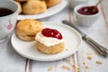 Tea time with delicious scones with clotted cream and strawberry jam Royalty Free Stock Photo