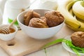 Tea time: homemade banana muffins, honey, bananas and tea settings Royalty Free Stock Photo