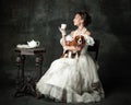 Tea time. Lady with dog. Vintage portrait of young elegant woman in image of medieval person in renaissance style dress Royalty Free Stock Photo