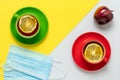 Tea time with lemon slices in the morning. Tea party for two and apple fruit. Two protective masks on the table in the cafe. Two Royalty Free Stock Photo