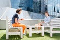 Modern freelancers having tea time on terrace together