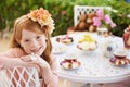 Tea-time with my Teddy. A little girl sitting outside having a tea party with her teddy bear. Royalty Free Stock Photo