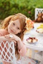 Tea-time with my Teddy. A little girl sitting outside having a tea party with her teddy bear. Royalty Free Stock Photo