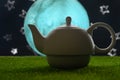 Tea time, oriental tales, teapot with oriental background, starry sky and moon. Delicious and spicy tea