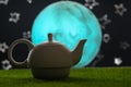 Tea time, oriental tales, teapot with oriental background, starry sky and moon. Delicious and spicy tea