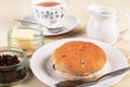 Tea with a traditional British teacake of raisins Royalty Free Stock Photo