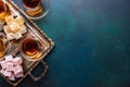 Tea in traditional glass cups  and  turkish delight  on dark blue-green painted wooden background  with empty space for text . Fla Royalty Free Stock Photo