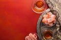 Tea in traditional glass cups  and  turkish delight  on red painted wooden background  with empty space for text . Flat lay. Selec Royalty Free Stock Photo