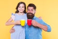 Tea for two. Happy family enjoy drinking tea together. Small daughter and father hold tea cups. Morning drink. Breakfast