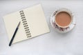 Tea in a vintage cup and saucer, and notebook with blank pages. Royalty Free Stock Photo