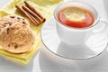 Tea in a white Cup with lemon, cinnamon and biscuits Royalty Free Stock Photo