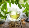 Tea on wooden boards with green leaves