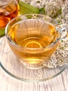 Tea with yarrow in glass cup on board Royalty Free Stock Photo