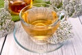 Tea with yarrow in glass cup on light board Royalty Free Stock Photo