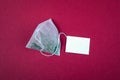 Teabag with white label. Top view, on a red background. Mockup Royalty Free Stock Photo