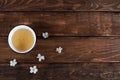 teabowl with white cherry flowers on wooden background.