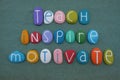 Teach, Inspire, Motivate, creative quote for an educational message composed with multicolored stone letters over green sand Royalty Free Stock Photo