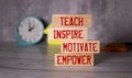 Teach inspire motivate empower, text words on wooden blocks