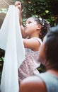 Teach kids responsibility by getting them involved in chores. a mother and her little daughter hanging up laundry on a