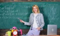Teacher with alarm clock at blackboard. Time. Study and education. Modern school. Knowledge day. woman in classroom Royalty Free Stock Photo
