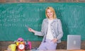 Teacher with alarm clock at blackboard. Time. Study and education. Modern school. Knowledge day. woman in classroom Royalty Free Stock Photo