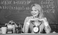 Teacher with alarm clock at blackboard. Time. Study and education. Modern school. Knowledge day. woman in classroom Royalty Free Stock Photo