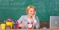 Teacher with alarm clock at blackboard. Time. Study and education. Modern school. Knowledge day. woman in classroom Royalty Free Stock Photo