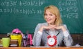 Teacher with alarm clock at blackboard. Time. Study and education. Modern school. Knowledge day. woman in classroom Royalty Free Stock Photo