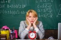 Teacher with alarm clock at blackboard. Time. woman in classroom. Back to school. Teachers day. Study and education Royalty Free Stock Photo