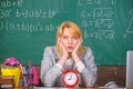Teacher with alarm clock at blackboard. Time. woman in classroom. Back to school. Teachers day. Study and education Royalty Free Stock Photo