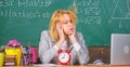 Teacher with alarm clock at blackboard. Time. woman in classroom. Back to school. Teachers day. Study and education Royalty Free Stock Photo