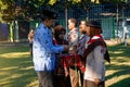 A teacher as the supervisor of the ceremony hangs the sign of the scouting participants at the school. Royalty Free Stock Photo